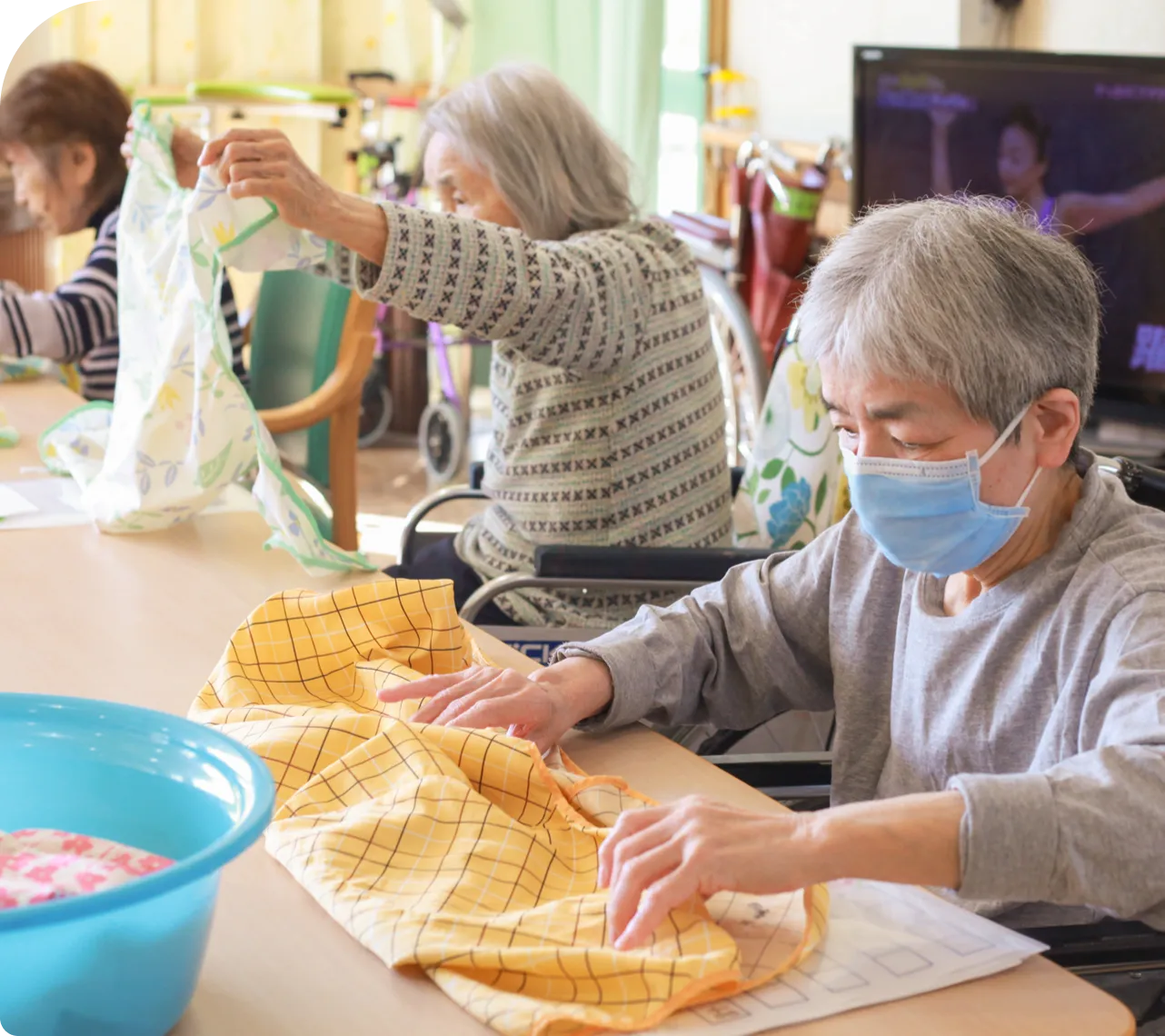 画像：洗濯物をたたむ入居者